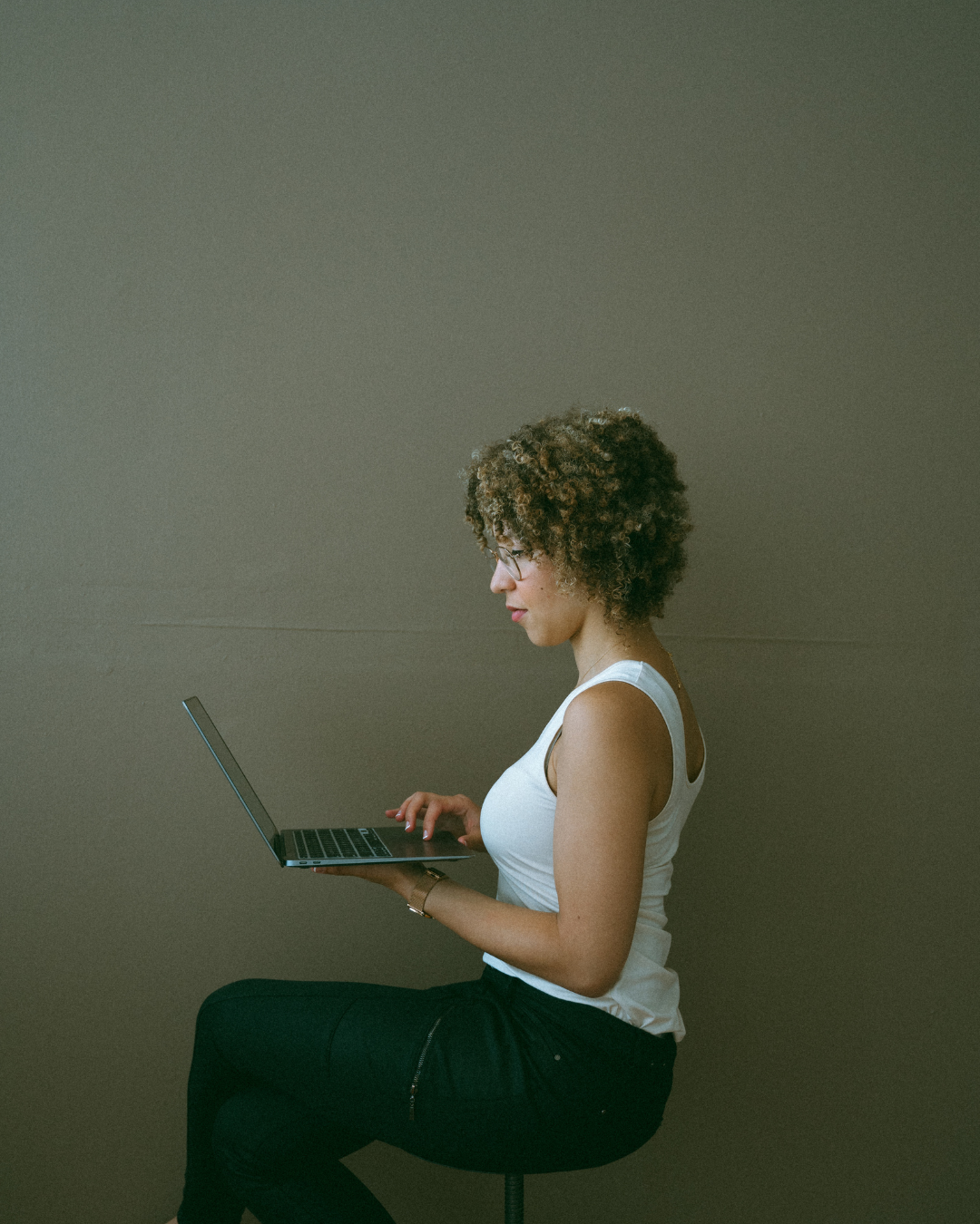 Woman sitting on chair working on social media content for a social media management client